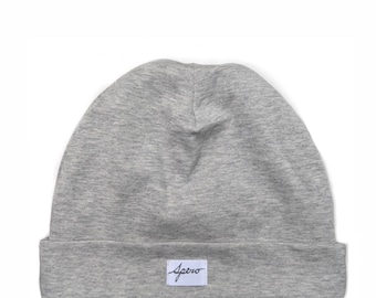 May include: A grey beanie with a white label that says "Spero" in black script.