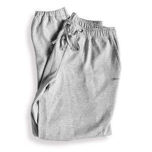 May include: Grey sweatpants with a drawstring waist and a small logo on the right leg.