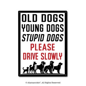 May include: Black and white metal sign with the text "Old Dogs Young Dogs Stupid Dogs Please Drive Slowly". The sign features a row of six black silhouettes of dogs of different sizes.
