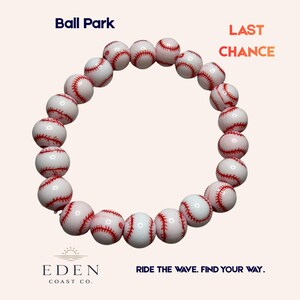 May include: A baseball-themed bracelet featuring white beads with red stitching, resembling baseballs. The bracelet is displayed against a light background, with the text "Ball Park" and "Last Chance" visible. The Eden Coast Co. logo and the phrase "Ride the wave. Find your way." are also present.