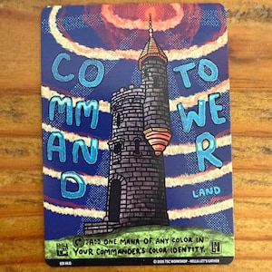 May include: A rectangular card with a stylized illustration of a tall tower. The card has a blue background with the words "COMMAND TOWER LAND" in a stylized font. The tower is gray with a red and orange top.