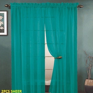May include: Two sheer turquoise curtains hanging in a window. The curtains are made of a lightweight fabric and have a subtle sheen. The text "2PCS SHEER TURQUOISE" is visible at the bottom of the image.