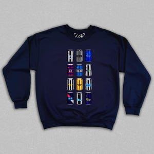 May include: Navy blue sweatshirt featuring a graphic of twelve beer cans with various designs. The cans are arranged in three rows of four. The sweatshirt has a crew neck and long sleeves. The text "/.OD" is printed on the top.