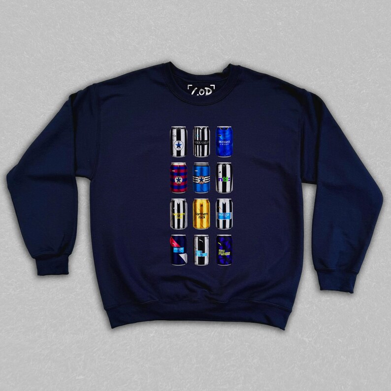 May include: Navy blue sweatshirt featuring a graphic of twelve beer cans with various designs. The cans are arranged in three rows of four. The sweatshirt has a crew neck and long sleeves. The text "/.OD" is printed on the top.