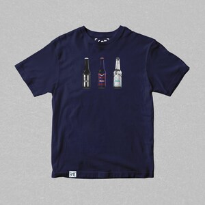 May include: A navy blue t-shirt with a graphic of three beer bottles. The bottles are different colors and have different labels. The shirt has a small tag on the bottom right corner.