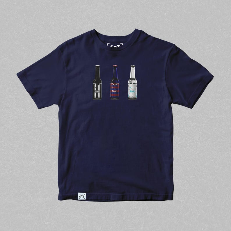May include: A navy blue t-shirt with a graphic of three beer bottles. The bottles are different colors and have different labels. The shirt has a small tag on the bottom right corner.