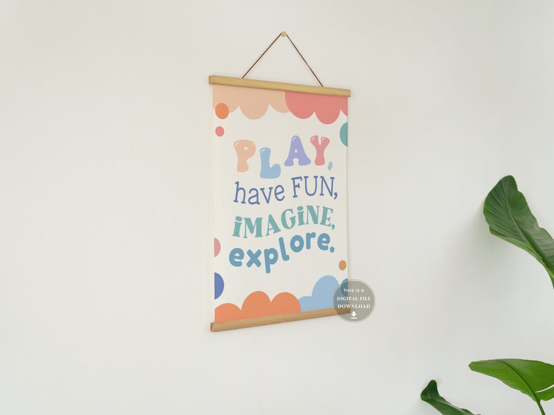 May include: A printable wall art print with a white background and colorful text that reads "PLAY, have FUN, IMAGINE, explore." The text is surrounded by colorful circles and clouds.