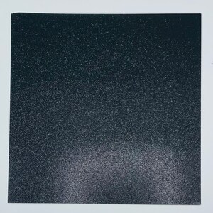May include: A black sheet of glitter paper with a subtle gradient of lighter glitter towards the bottom.