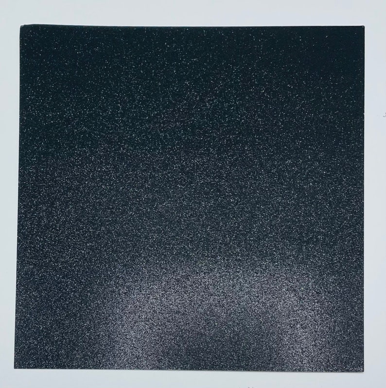 May include: A black sheet of glitter paper with a subtle gradient of lighter glitter towards the bottom.