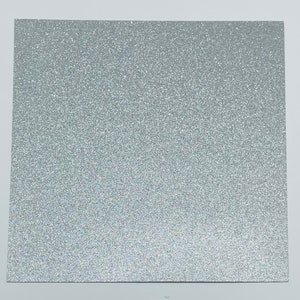 May include: A sheet of silver glitter paper. The paper has a fine, even glitter texture.