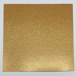 May include: A sheet of gold glitter paper. The paper has a fine, even glitter texture.