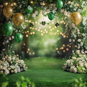 May include: A green and white backdrop with green and gold balloons, white flowers, and green shamrocks. The background is a blurred image of a green forest.