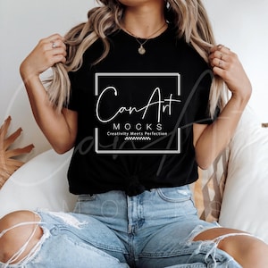 May include: A black t-shirt with a white graphic design that says "Can Art Mocks" and "Creativity Meets Perfection".