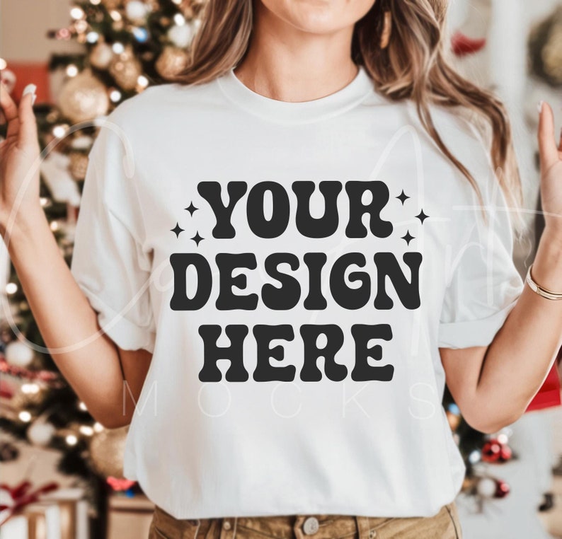 May include: White t-shirt with the text "YOUR DESIGN HERE" in black retro-style lettering.