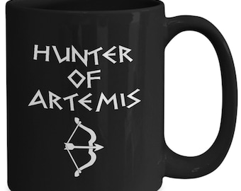 May include: Black ceramic coffee mug with a white design that says "Hunter of Artemis" with a stylized bow and arrow.