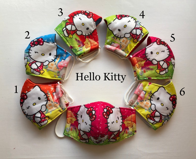 May include: Six Hello Kitty face masks in different colors and patterns. The masks are numbered 1 through 6. The masks are all made of fabric and have a white elastic band.