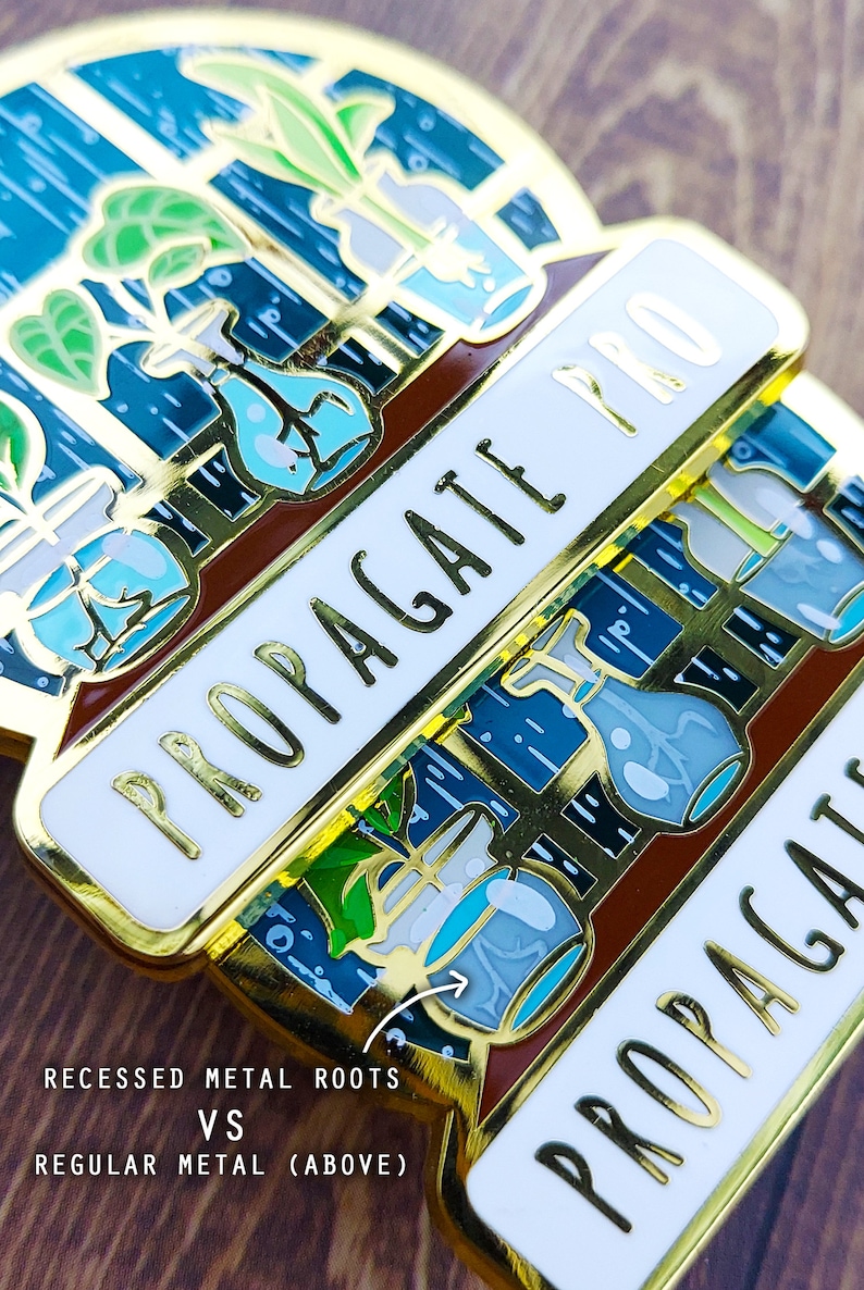A detailed close up shot of 2 propagating plant enamel pins that shows the difference between some of their metal lines. The mini glass jars in the design show off the plant cuttings and their sprouting roots on a floating window shelf.