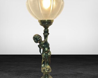 Wonderful mid-century brass table cherub lamp with a faceted glass globe shade in the shape of a flower with a bubble top