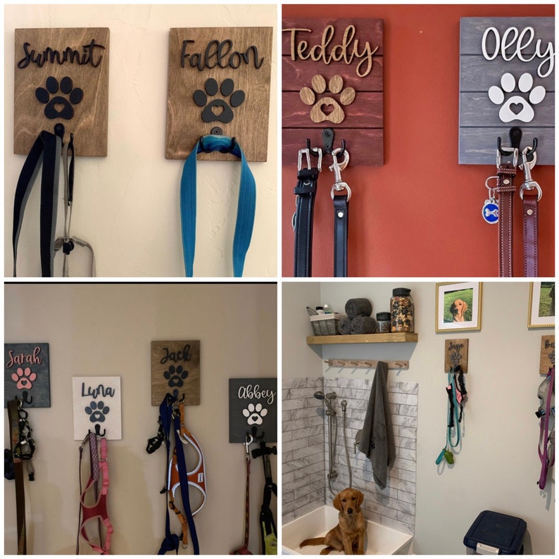 K&ouml;nnte beinhalten: Ein Satz aus Holz-Haken f&uuml;r Hundeleinen mit Pfotenabdr&uuml;cken und personalisierten Namen. Die Haken sind an einer Wand montiert und haben Leinen, die daran h&auml;ngen. Die Namen auf den Haken sind Summit, Fallon, Teddy, Olly, Sarah, Luna, Jack und Abbey.