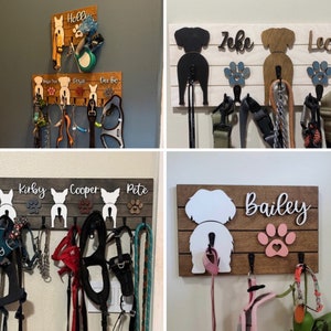 May include: Four wooden dog leash holders with dog silhouettes and names. The holders are mounted on a wall and have hooks for hanging leashes. The names on the holders are Kirby, Cooper, Pete, Bailey, Zeke, Leo, Holly, Rosie, and Dee-Dee.