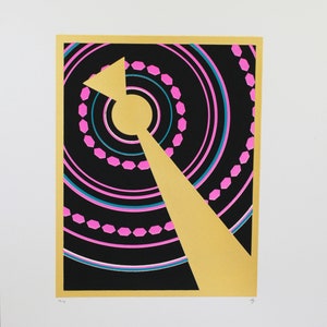 May include: A gold and black geometric print with pink and blue accents. The print features a large gold triangle with a circle in the center.