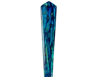 May include: A blue and green iridescent abalone shell shaped like a pointed dagger.