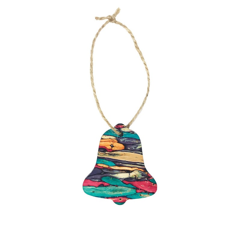 May include: A colourful bell ornament with a rustic twine hanger. The bell is made of wood and has a multi-coloured, abstract pattern.