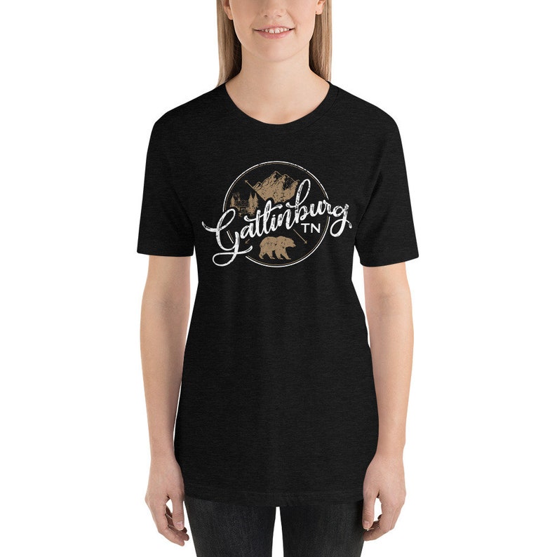 May include: Black t-shirt with a white graphic of a circle with a bear, mountains, and the text "Gatlinburg TN".