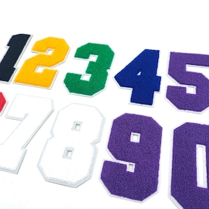 May include: Ten felt patches with numbers 1 through 10. The patches are in various colors, including red, white, green, blue, yellow, and purple.