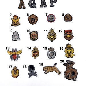 May include: Twenty embroidered patches with various designs, including letters, animals, and crowns. The patches are numbered 1 through 20.