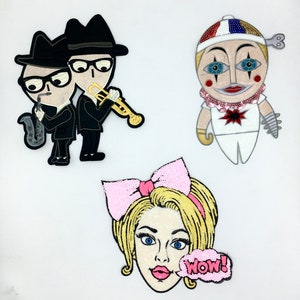 May include: Three sequined patches: two musicians in black suits and hats, one playing a saxophone and the other a trumpet; a clown with a key on its head; and a woman's face with a pink bow and a "WOW!" speech bubble.