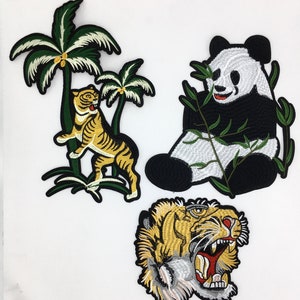 May include: Three embroidered iron-on patches featuring a panda bear eating bamboo, a tiger standing in front of a palm tree, and a tiger head.