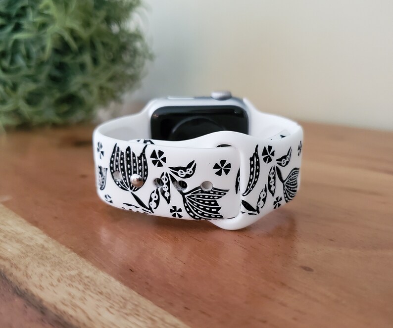 Może przedstawiać: Biały pasek do Apple Watch z czarno-białym wzorem kwiatowym.