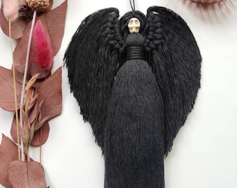 May include: Black macrame angel with a white skull head and long fringe.