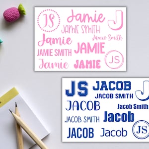 May include: Two sets of personalized name labels with different designs. The first set features the name "Jamie" in pink with a pink "JS" monogram. The second set features the name "Jacob" in blue with a blue "JS" monogram.