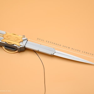 May include: A silver and gold dual-blade knife with a 20 cm blade length. The knife is extended and the blades are sharp.