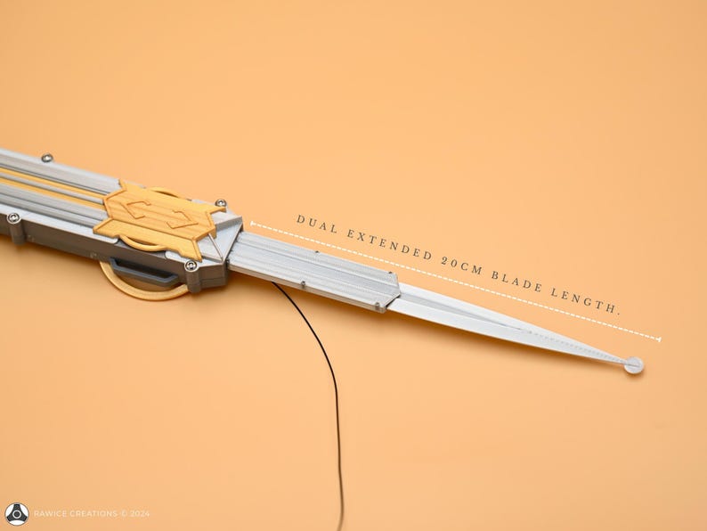 May include: A silver and gold dual-blade knife with a 20 cm blade length. The knife is extended and the blades are sharp.