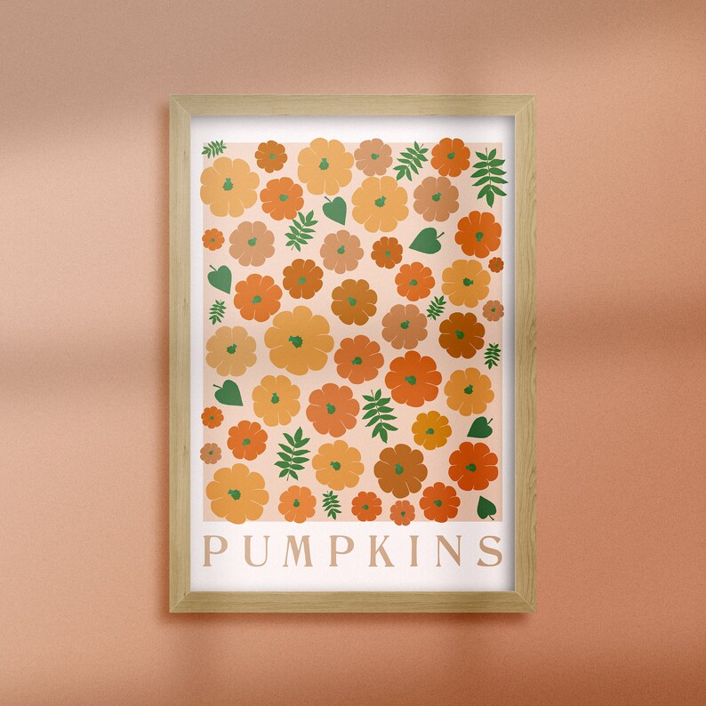 May include: A framed print featuring a pattern of orange, yellow, and brown pumpkins with green leaves. The print has the word "PUMPKINS" written in white at the bottom.
