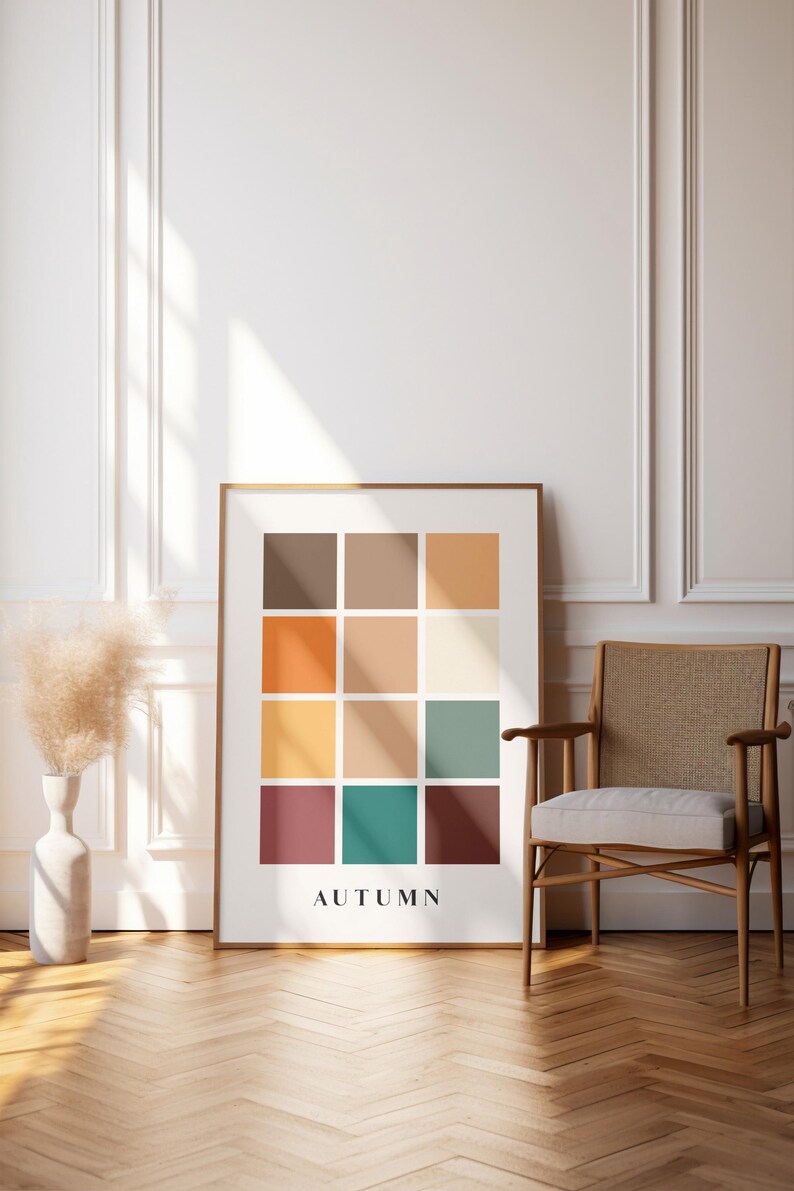 May include: A framed print with a grid of 12 colored squares in shades of brown, orange, yellow, green, and red. The word "AUTUMN" is printed below the grid.