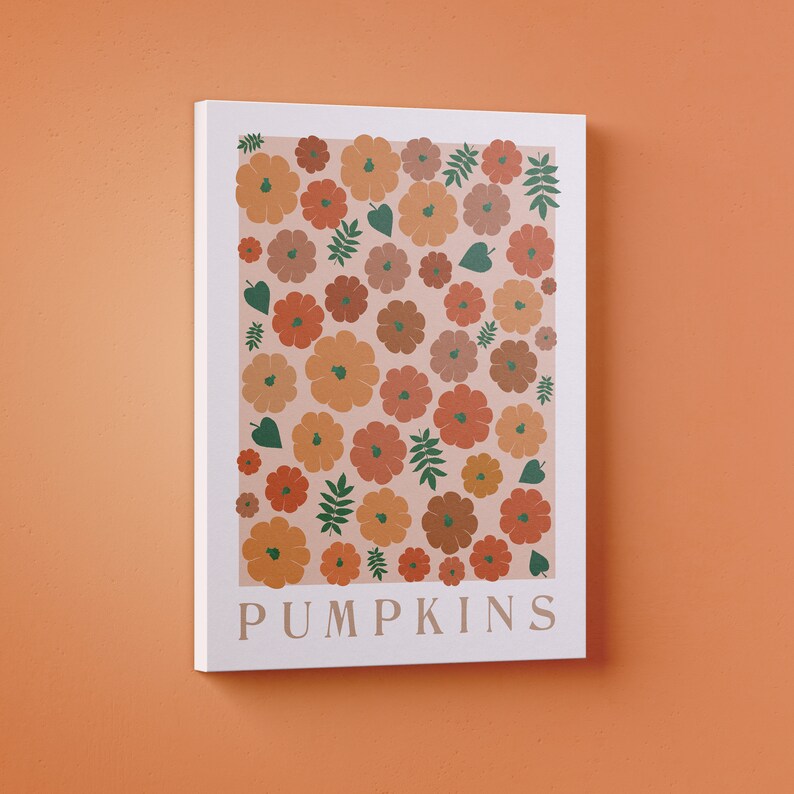 May include: A white canvas print featuring a pattern of orange, brown, and green pumpkins on a pale pink background. The text "PUMPKINS" is printed in green at the bottom of the print.