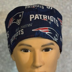 May include: A blue and white patterned surgical scrub hat with the words "Patriots" and "Go Pats!" printed on it.