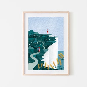 May include: A framed illustration of a white cliff with a red and white lighthouse on top. A winding path leads up to the lighthouse, with a couple walking along the path. The sky is blue with rain falling.