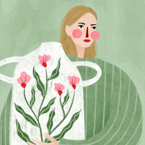 May include: A woman in a green striped shirt holds a white ceramic vase with a floral design. The vase has pink flowers and green leaves.