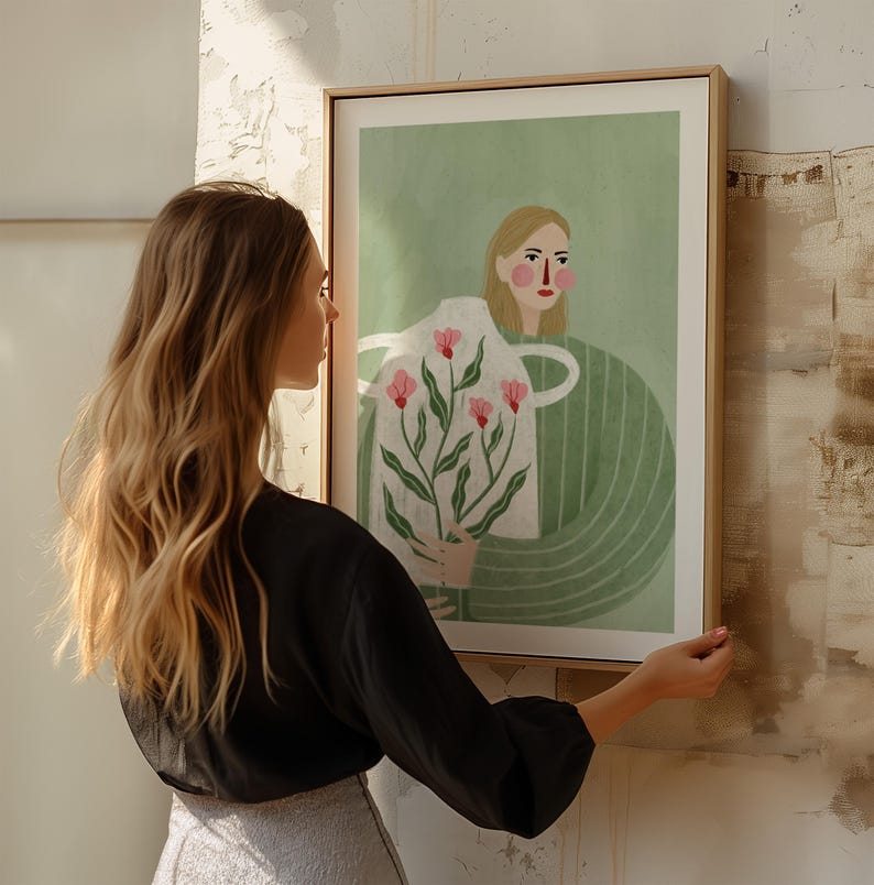 May include: A framed illustration of a person holding a vase with pink flowers. The person has blonde hair and is wearing a green shirt. The background is a light green color.