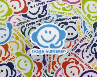 May include: A collection of colorful stickers with a smiling face design and the text "Stage Manager".