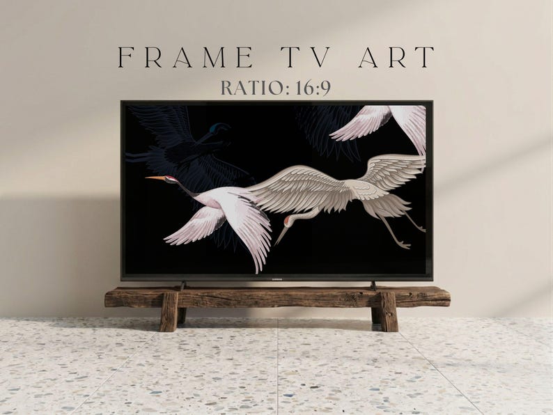 May include: A black framed TV displaying a digital art print of white cranes with outstretched wings against a black background. The TV is mounted on a rustic wooden stand. Text at the top reads "FRAME TV ART" and "RATIO: 16:9".
