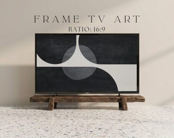May include: A black framed TV displaying abstract art with a black and white design. The TV is mounted on a rustic wooden stand. The text "FRAME TV ART" and "RATIO: 16:9" are displayed above the TV.