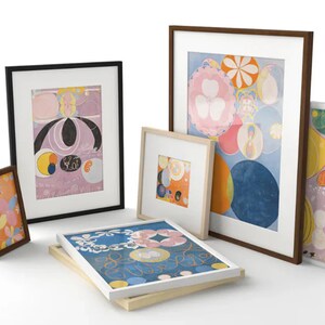 May include: A collection of framed art prints featuring abstract designs in various colors. The frames are in different sizes and styles, including black, brown, and natural wood. The artwork includes floral and geometric patterns.
