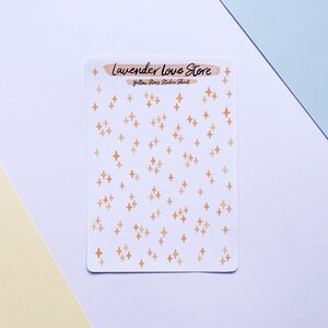 May include: A sheet of yellow star stickers with a white background. The sheet has the text "Lavender Love Store" and "Yellow Stars Sticker Sheet" printed on it.