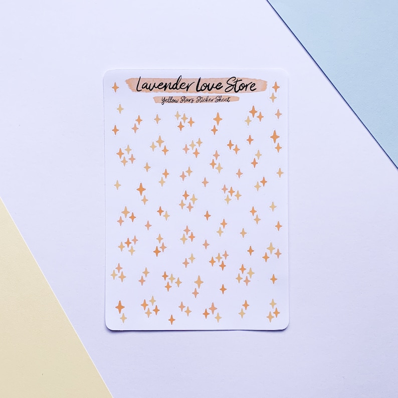 May include: A sheet of yellow star stickers with a white background. The sheet has the text "Lavender Love Store" and "Yellow Stars Sticker Sheet" printed on it.